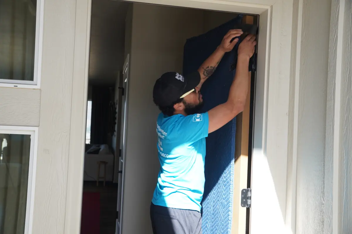 Single mom organizing moving boxes with child