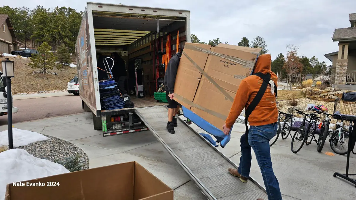 Professional movers loading items into truck