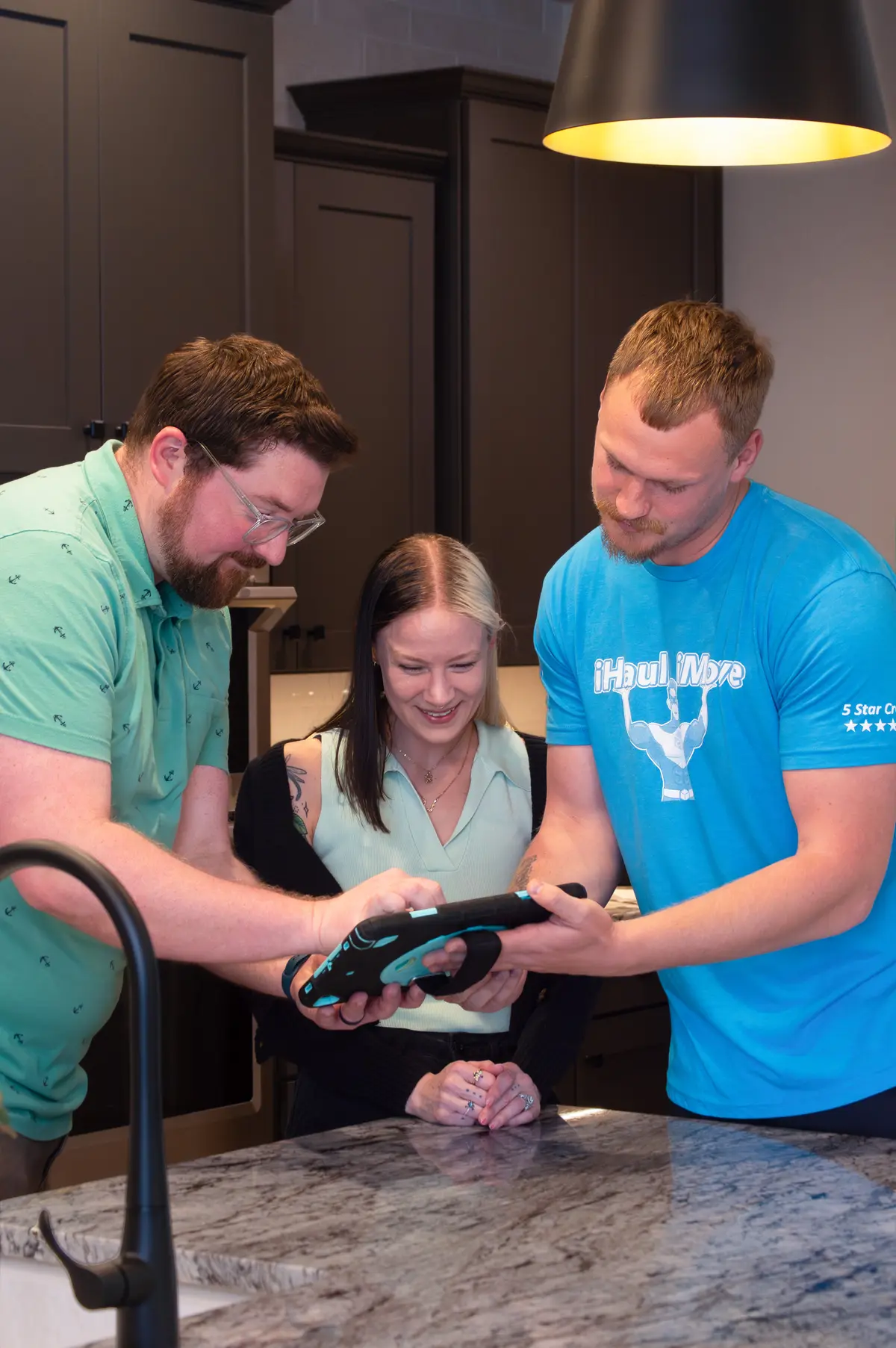 Moving crew and clients reviewing moving plan together