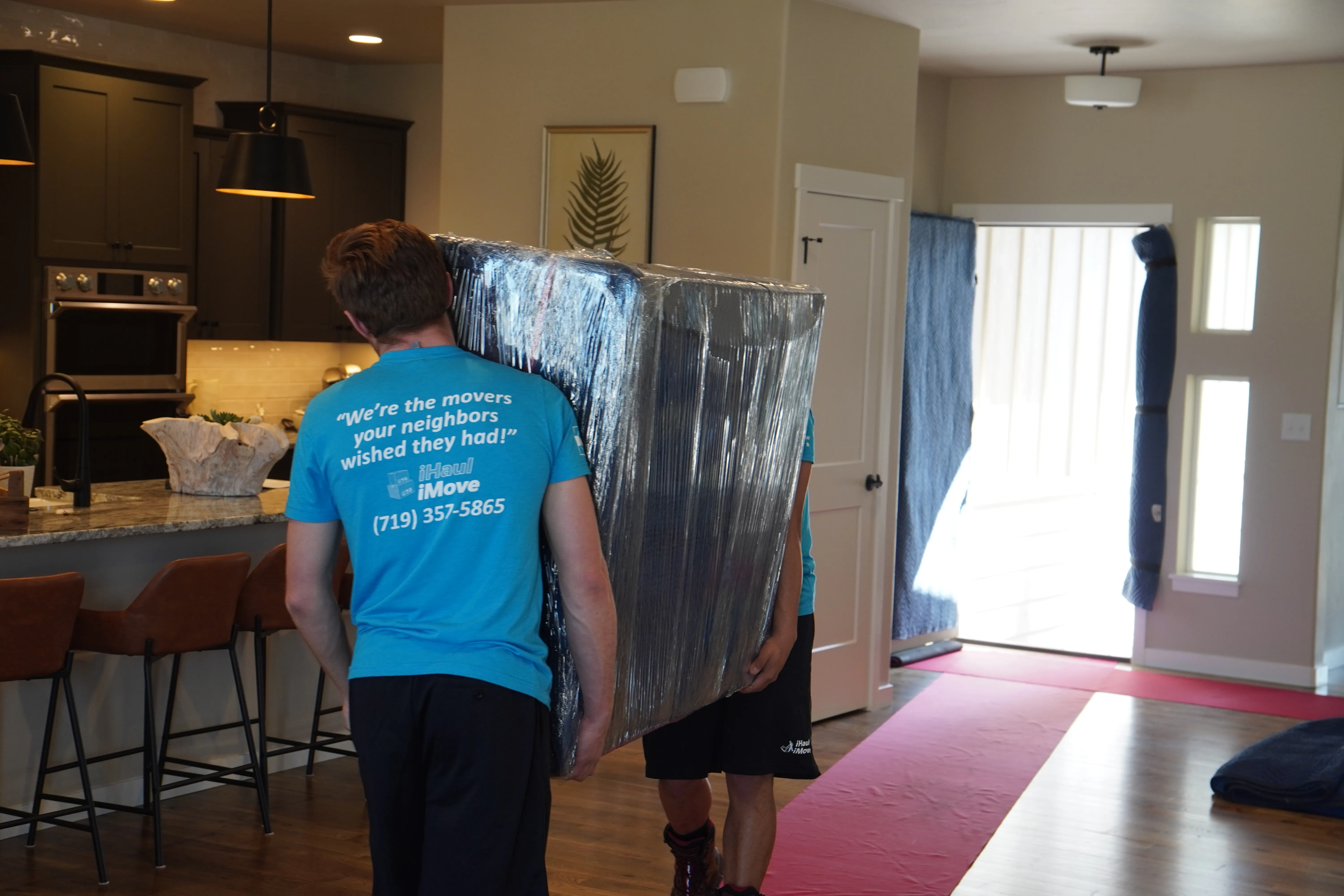 Professional movers loading household items into a moving truck